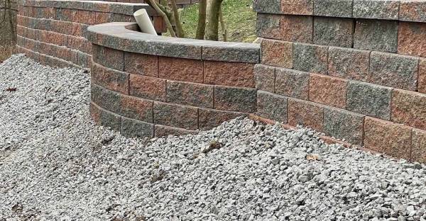 retaining wall with lot of gravels with cement underneath