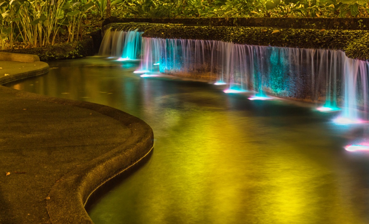Water feature spillway lit from below by color-changing underwater LED lights