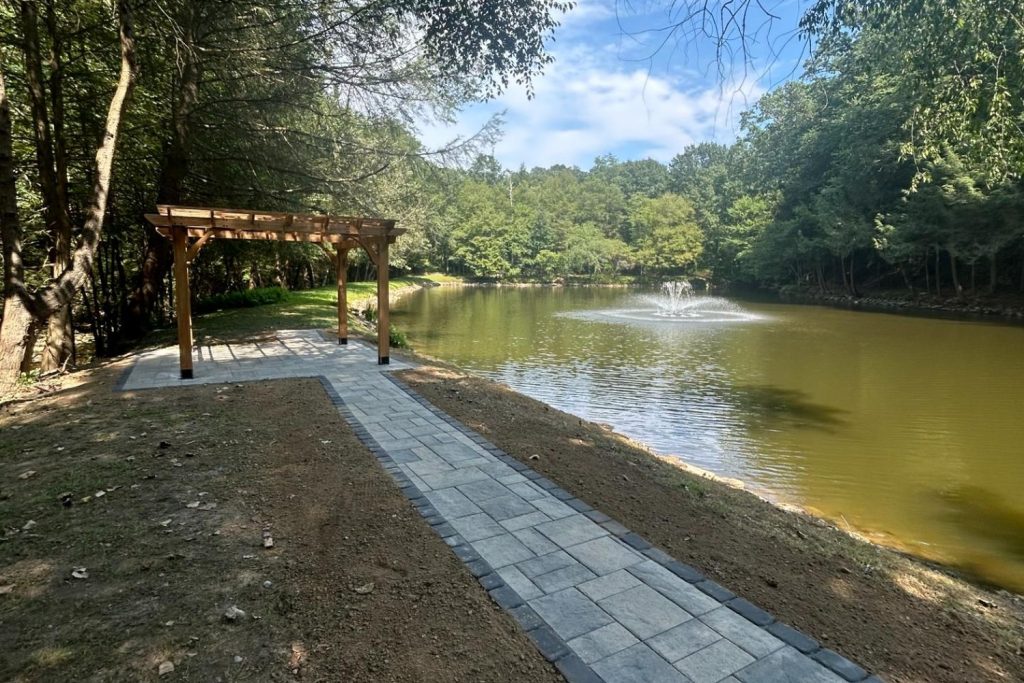 Pergola over a finished lakeside patio built by Daily Landscaping in Sarver, Butler County PA