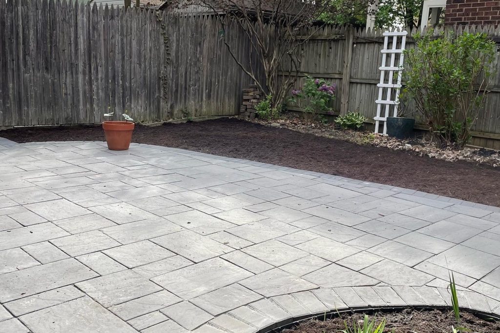Paver patio bordered by a freshly mulched bed with clean edging, built by Daily Landscaping in Western Pennsylvania