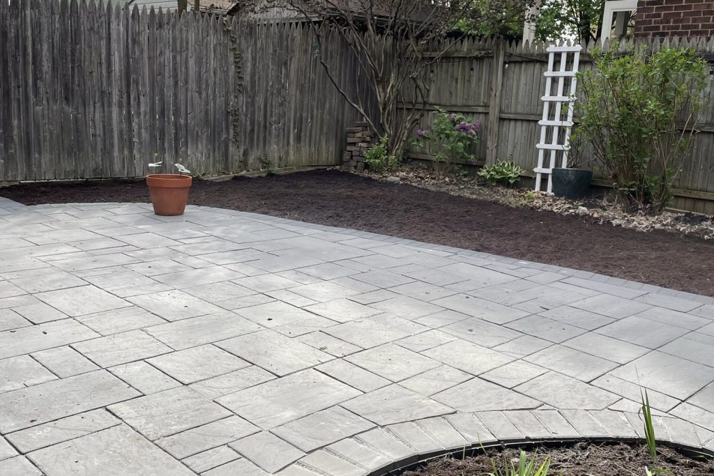 Paver patio bordered by fresh planting beds and new shrubs, installed by Daily Landscaping in Western Pennsylvania