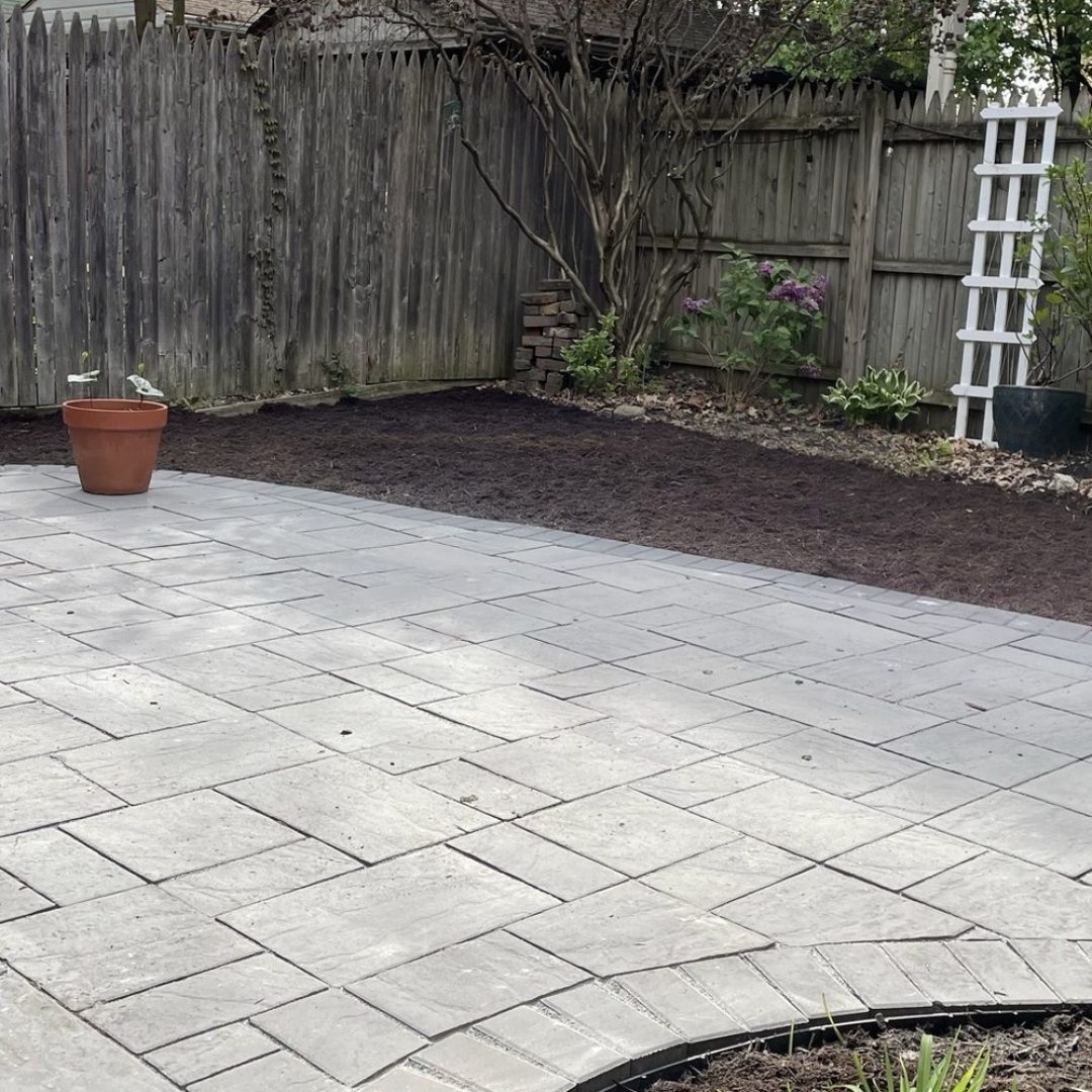 Paver patio bordered by fresh planting beds and new shrubs, installed by Daily Landscaping in Western Pennsylvania